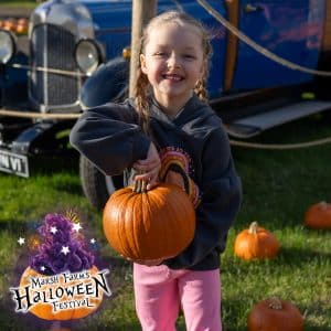 Little girl holding a pumpkin