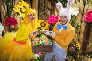 Happy easter actors holding a large box of eggs