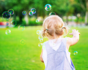 Toddler chasing bubbles