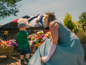 Toddler looking at flowers with the Fairy Godmother