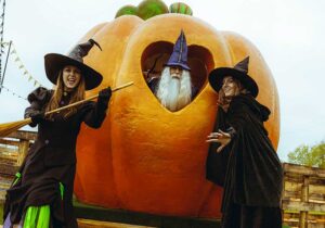Witches and wizard with a giant pumpkin