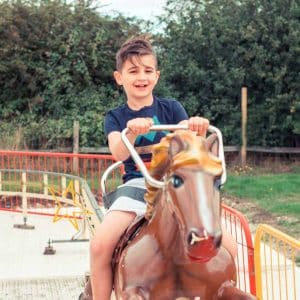 Boy on the Gallopers at Marsh Farm
